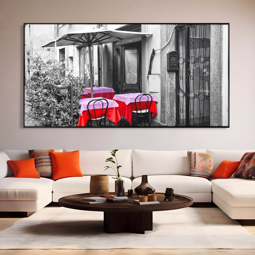 Tablou canvas cu cafenea stradala vintage alb negru cu pete de rosu, in rama de aluminiu negru, pe perete intr-un living